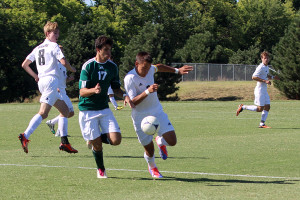 Senior Sam Taylor dribbles the ball around Shawnee Mission South senior Marcelo Regis.