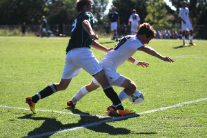 Senior Tyler Cross fights for the ball against an opposing Raider.