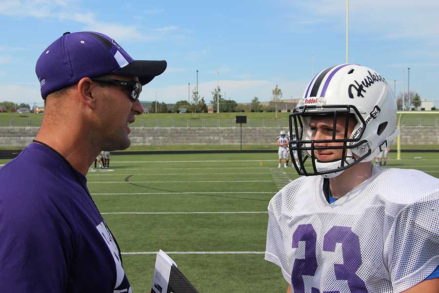 Head football coach Mike Zegunis instructs junior Garret Tierney during football practice.