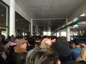 Rally attendees wait outside the Kansas City Convention Center before the doors open to let people in.