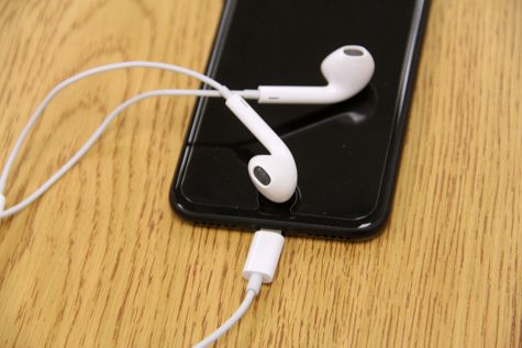 Apple's new ear pods connect to the lightning port rather than the headphone jack, which was removed in this generation of iPhone